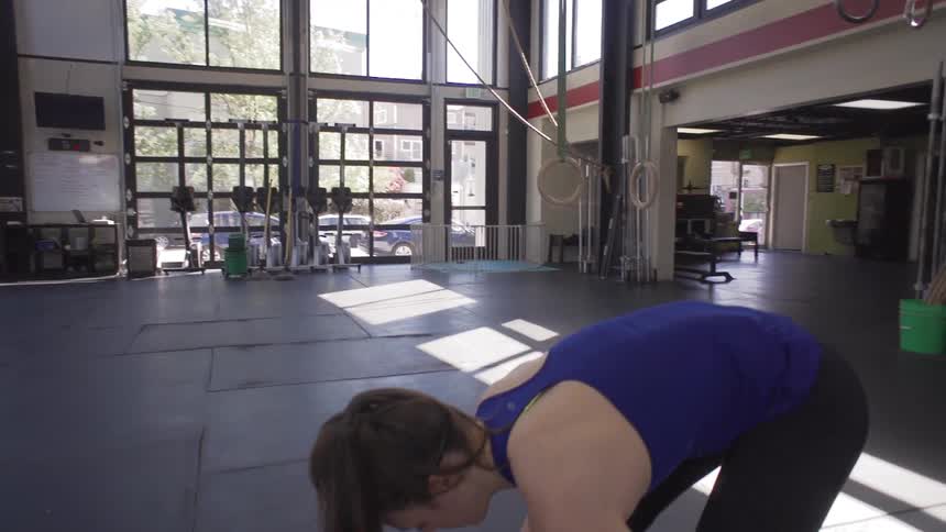 A woman sets weights on a bar