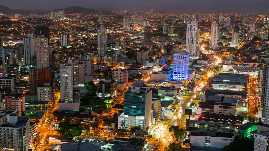 Traffic runs through a city at dusk
