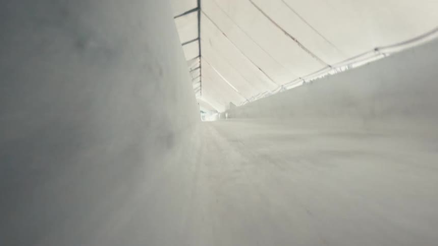 Point of view of a luge rider on a luge track going very fast