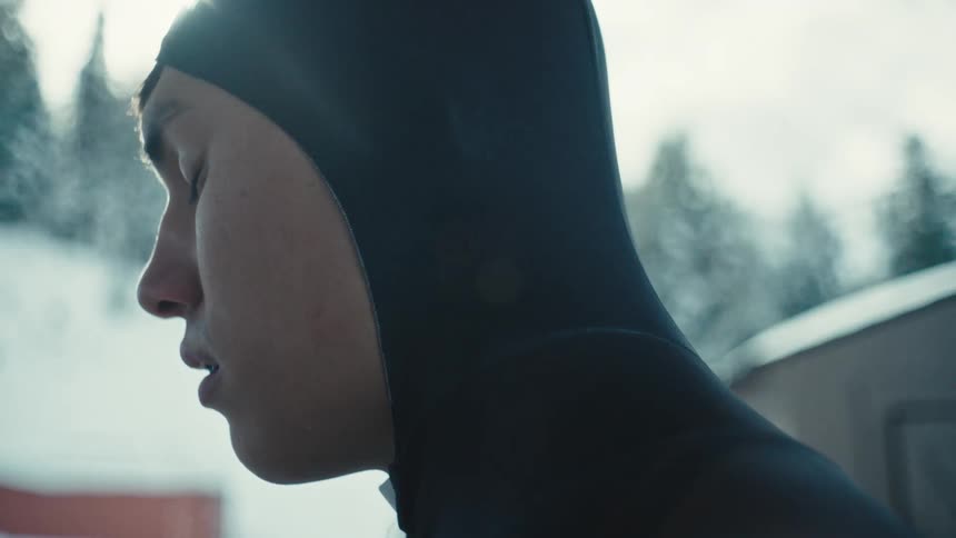 A man closes his eyes outside