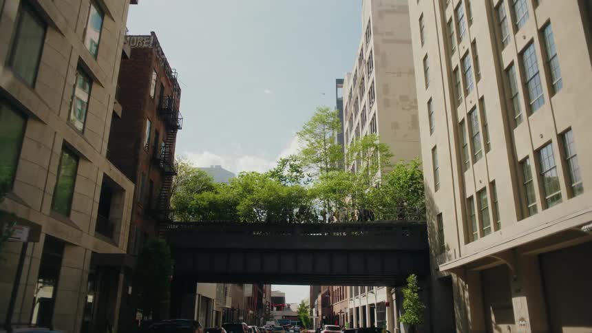 People cross a walkway between two buildings