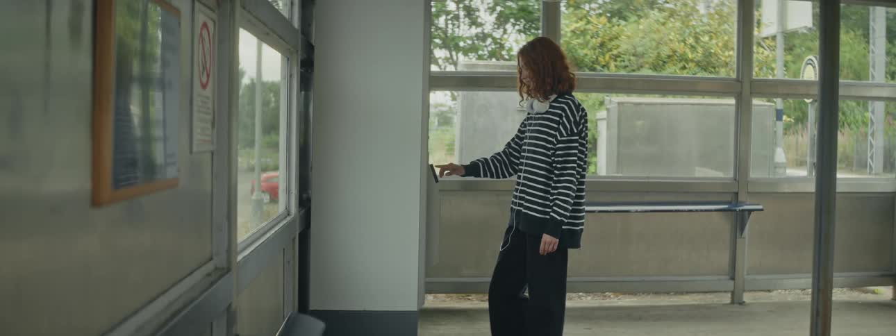 Woman interacting with a totem in an indoor space