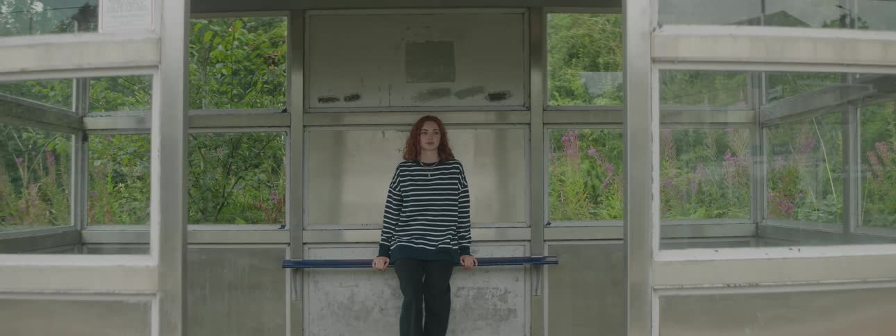 A woman waits for a bus