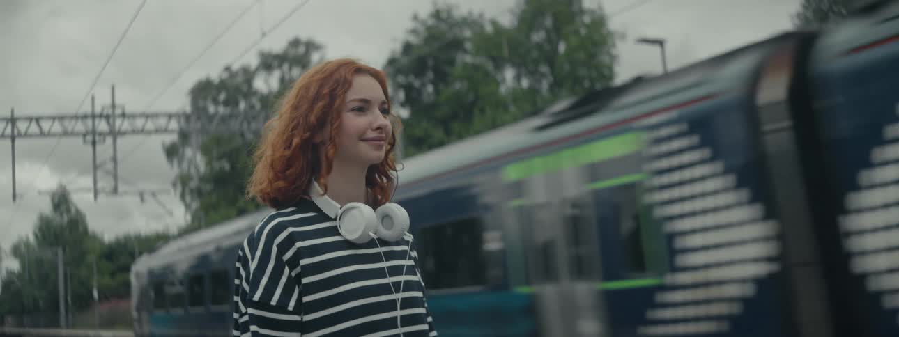 A clip of a lady standing by the rail