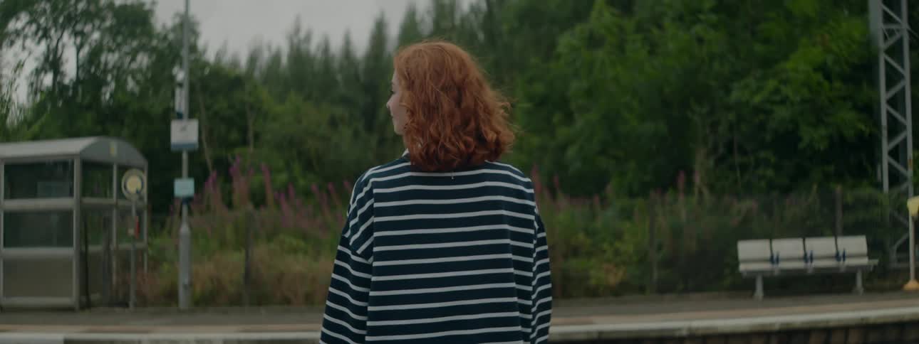 A woman waits for a train