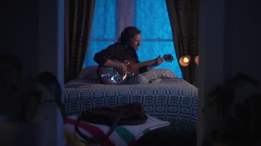 A close up clip of a person playing a guitar