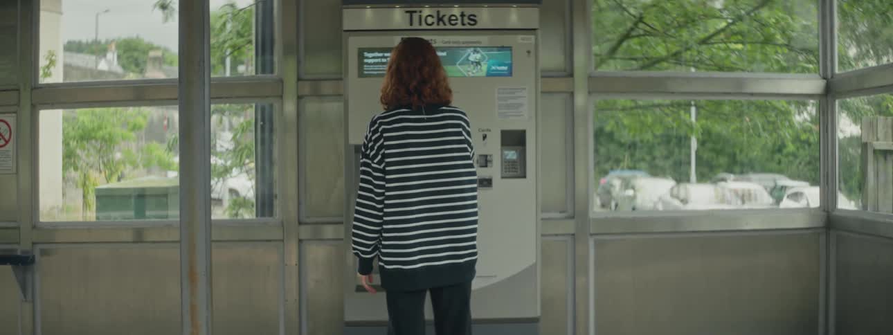 Woman in front of a ticket machine