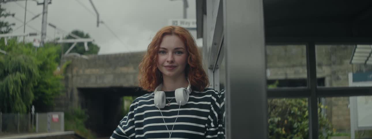 A woman waits for a train