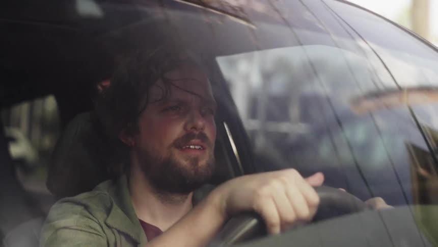 A man is driving through town
