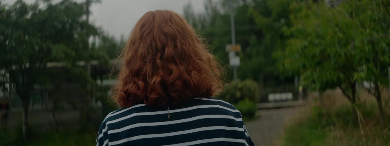 A back view of a lady walking a pathway