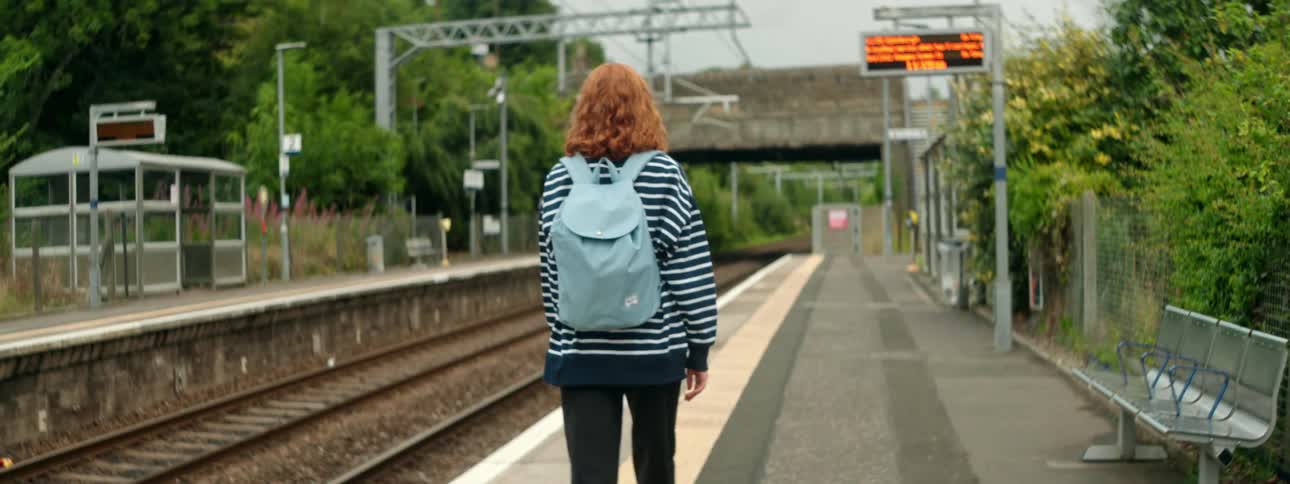 A woman waits for a train