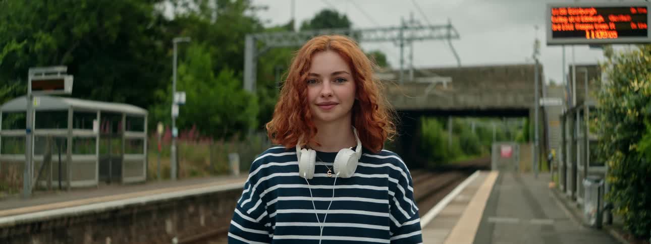 A woman waits for a train