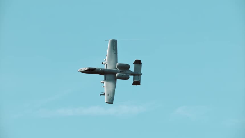 A bomber is flying past the clouds high in the sky