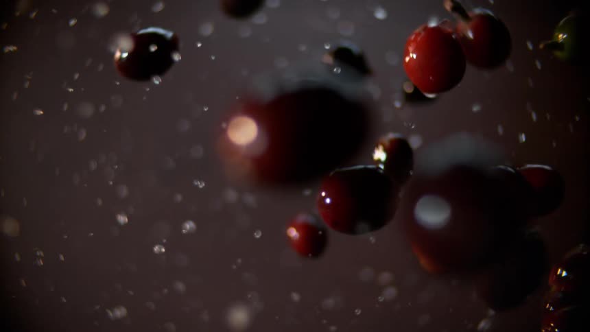 A bunch of cherries are tossed in water