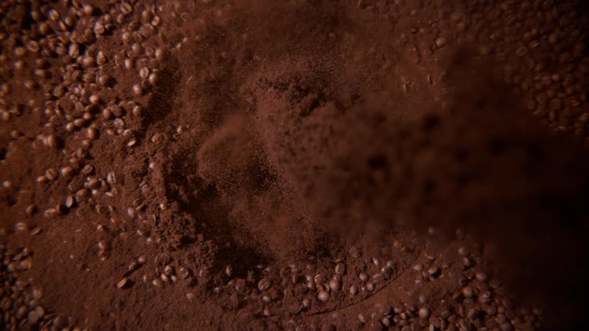 Coffee grounds fall into the pile