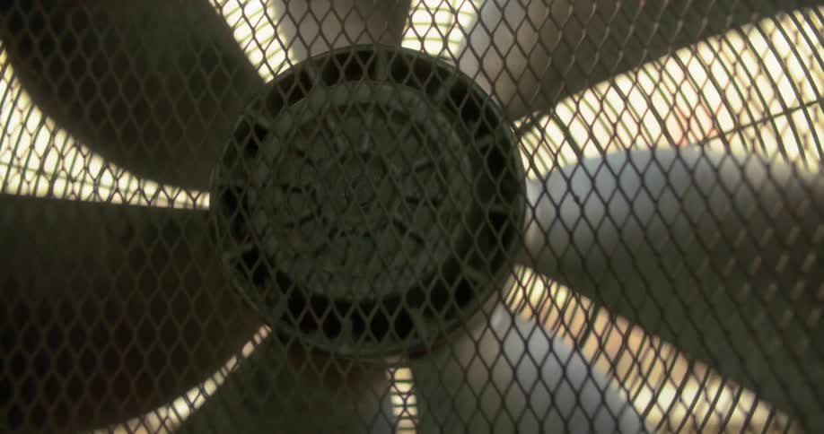 Close up of a metal fan roating clockwise