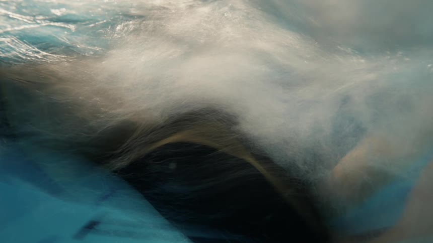 A woman is swimming in the pool