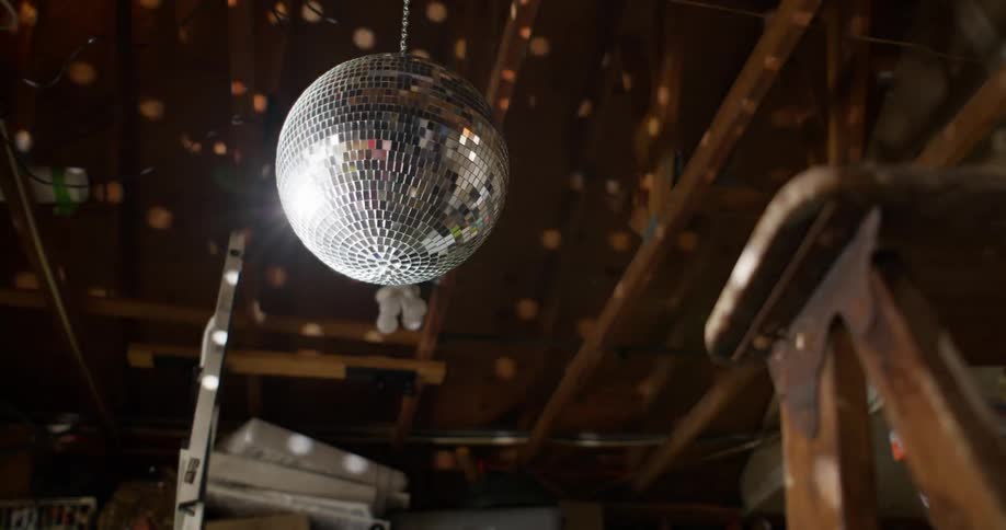 Disco ball hanging from the ceiling in a wooden setting