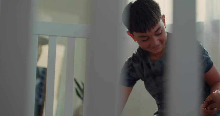 A boy is handing screws while building a crib