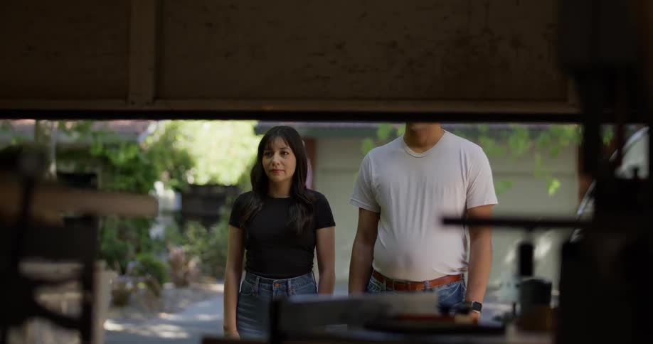 Garage door opening and a man and a woman watching