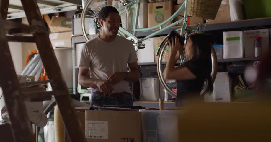 Couple in a garage with several boxes
