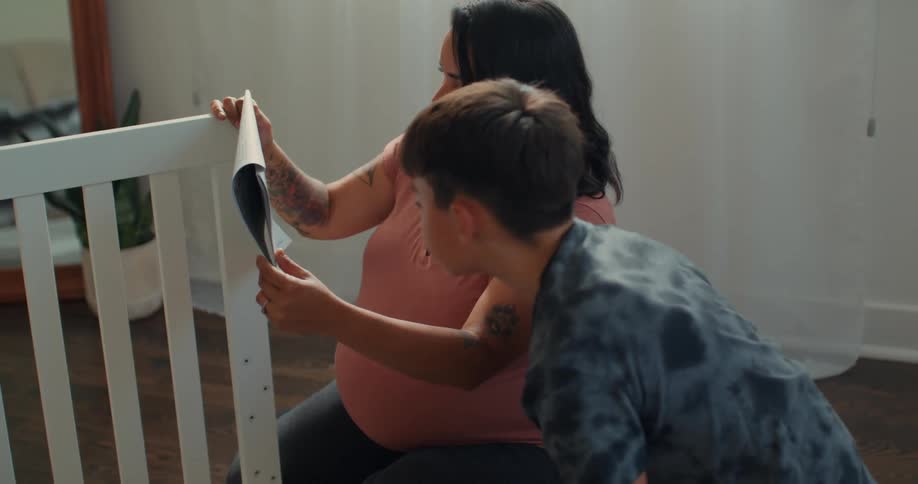 Mother next to her son looking at a manual