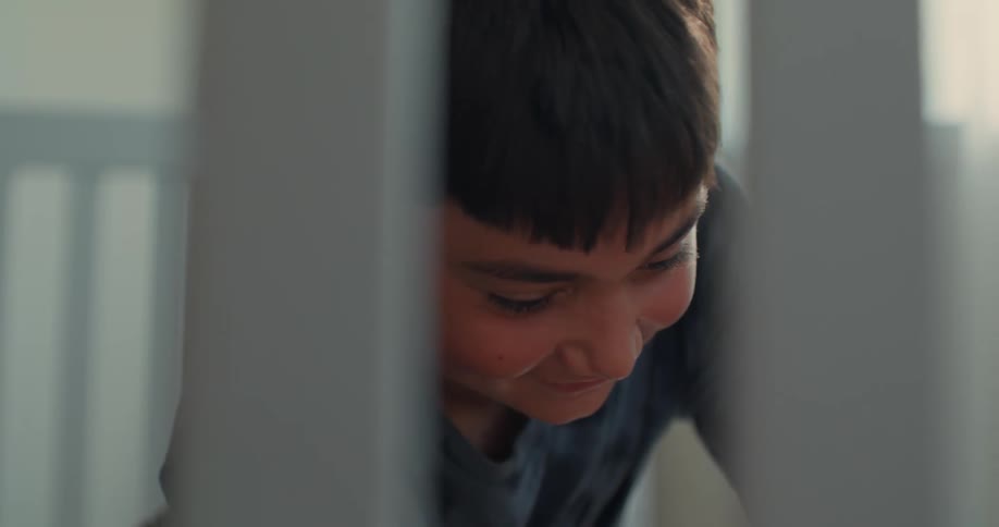 Portrait of a boy in an indoor space smiling