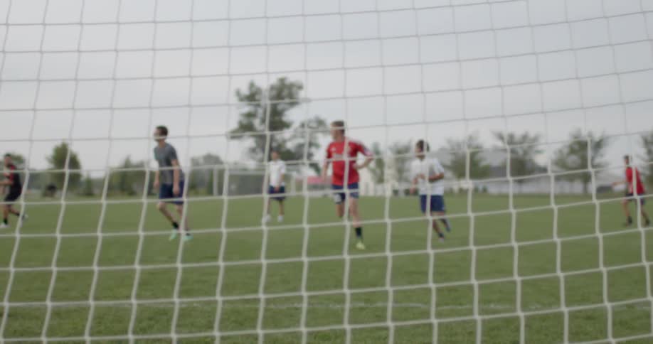 Soccer players run on the field