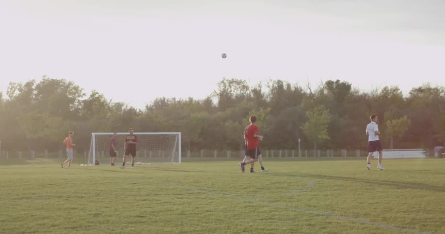 Soccer players play outside on a sunny day