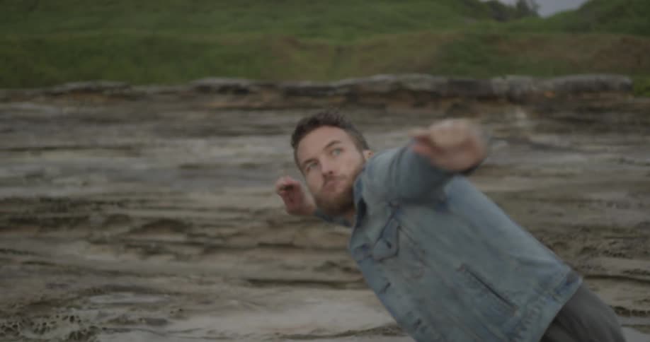 A man throws a stone on the beach
