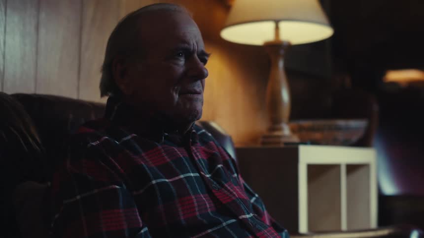 Elderly man sitting watching TV