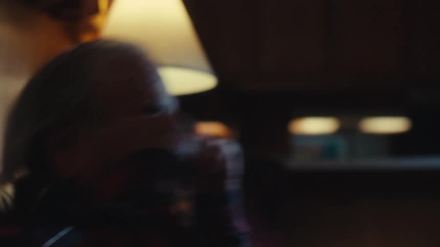 An elderly persons happy reaction to something on television