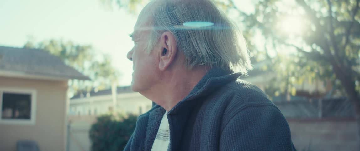 A man is looking around in the yard
