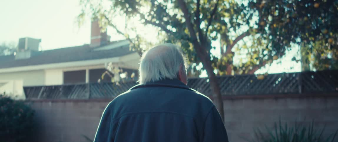 A man is walking around in his yard