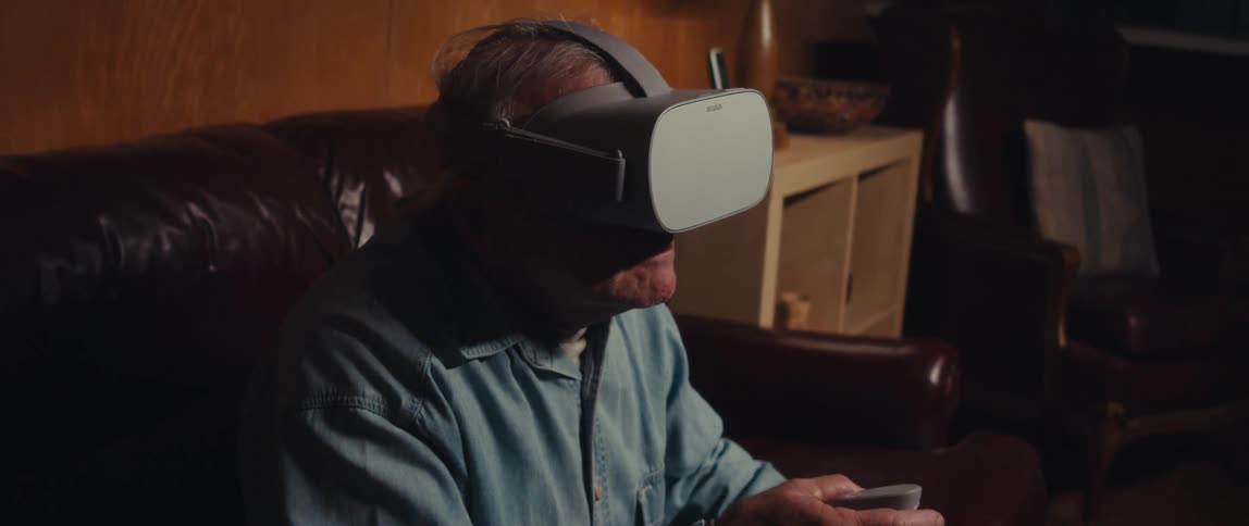 Elderly man sitting using vr headset