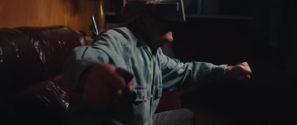 Elderly man using virtual reality glasses and having fun