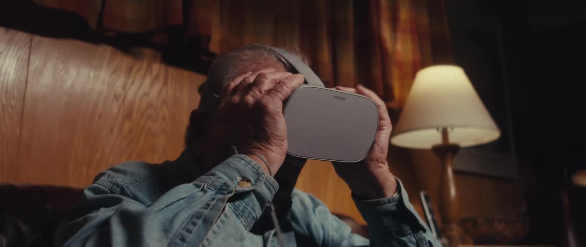 Elderly man putting on a vr headset