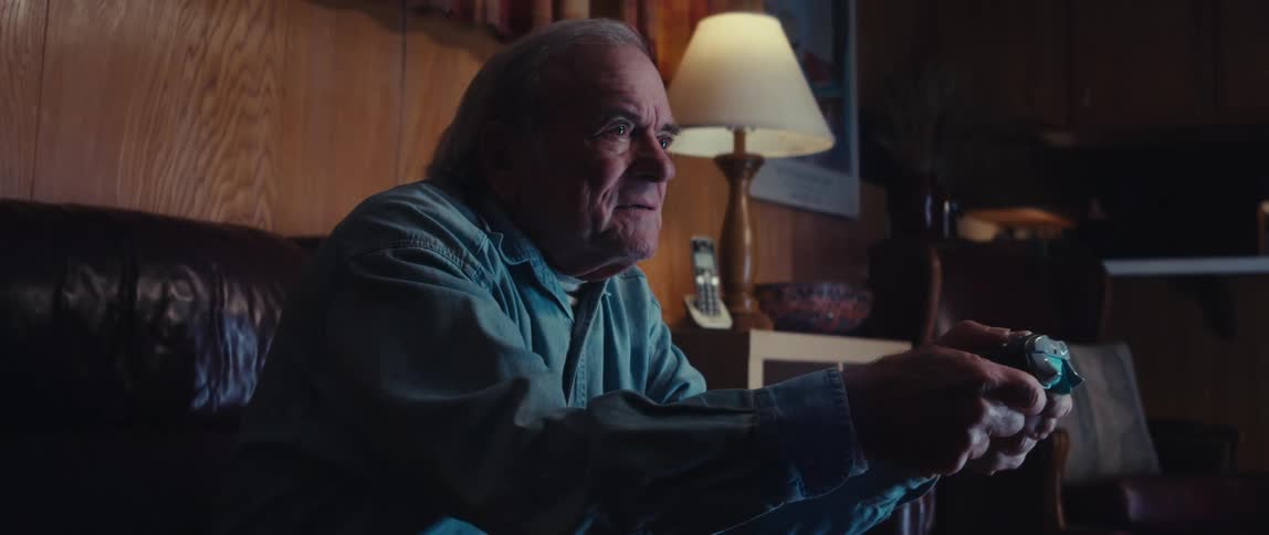 Elderly man having fun playing video games