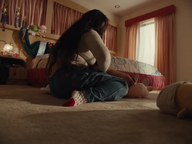 A mother and daughter are having a pillow fight