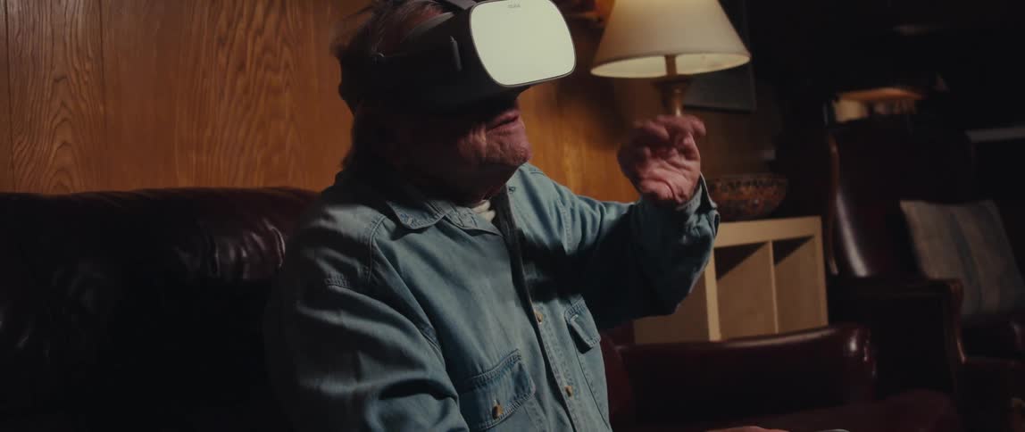 Elderly man sitting using a vr headset