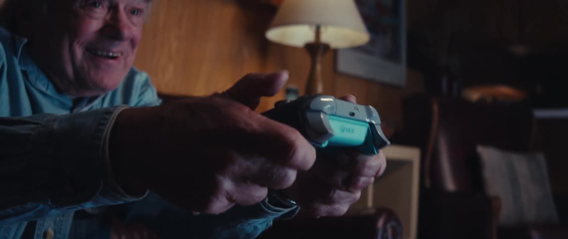 Excited elderly man holding video game controller playing a game