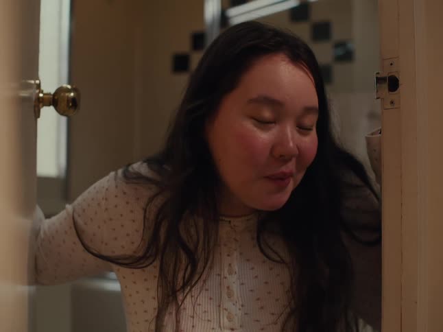 A clip of an asian lady coming out from the toilet