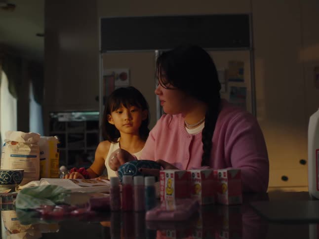 Teenager and a child in the kitchen cooking together