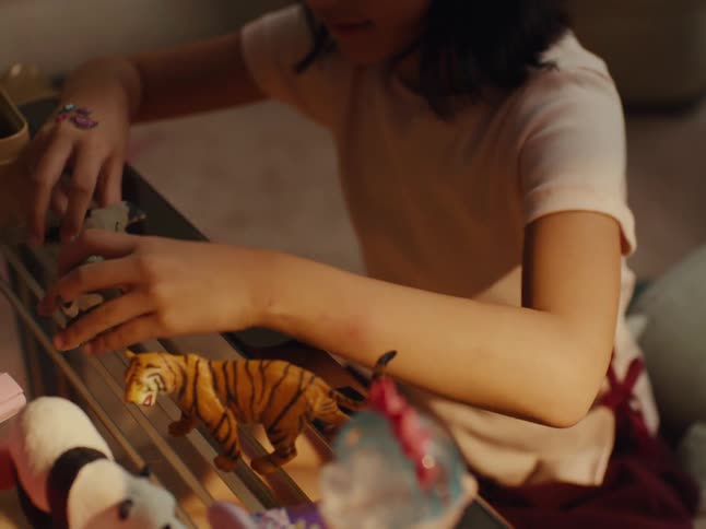 A child is playing with her toys