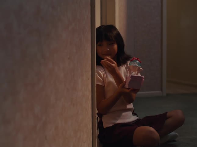 A child plays with her toy then knocks on the door