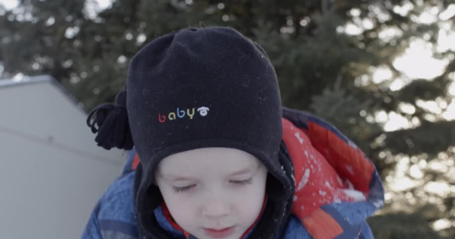 A kid is helping shovel the snow