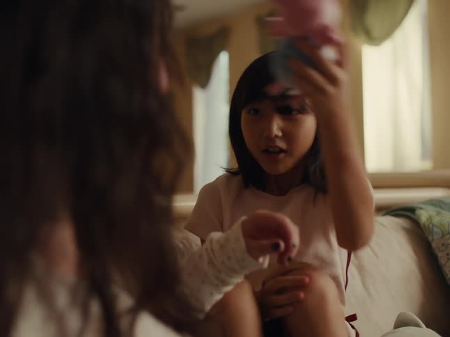 Sisters play together using stuffed animals