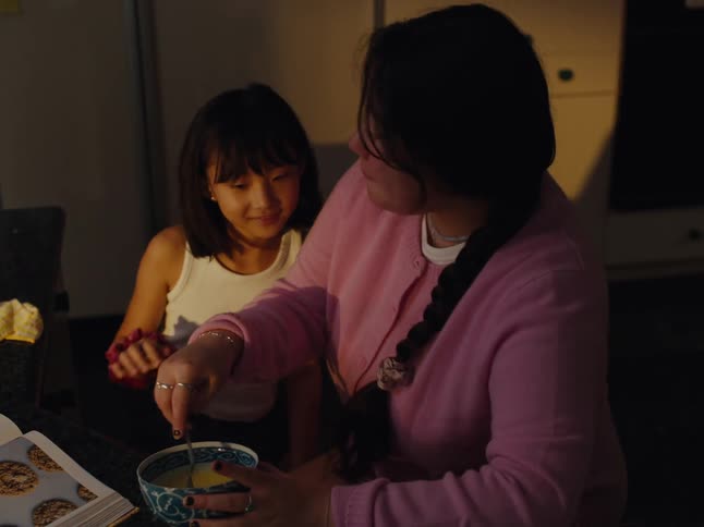 Two sisters are cooking in the kitchen