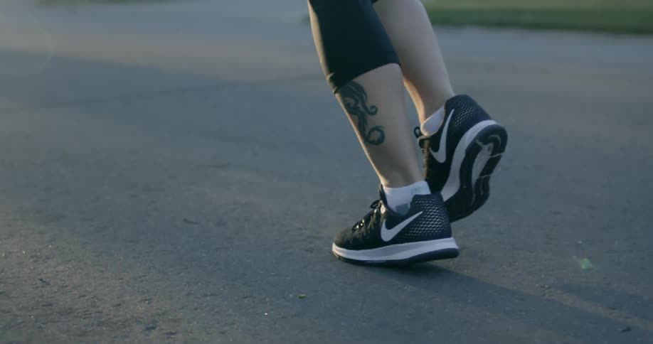 Filming someones legs as they are jogging down the road