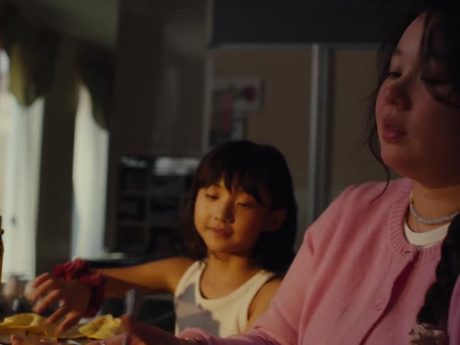 A mother and daughter are preparing food mixing something in a bowl